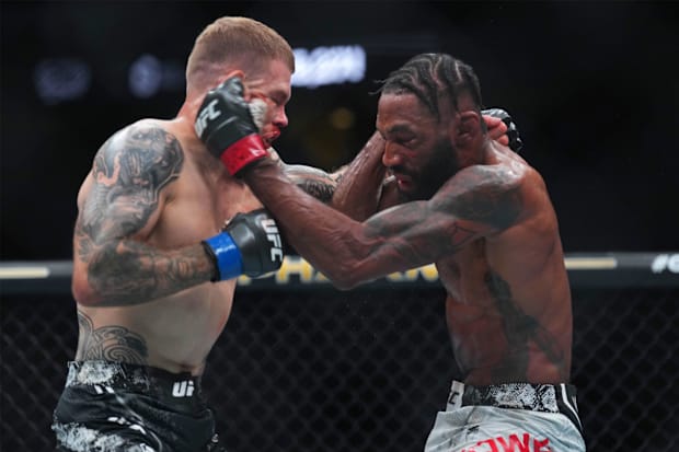 Phil Rowe (red gloves) fights Jake Matthews (blue gloves) during UFC 302 at Prudential Center.
