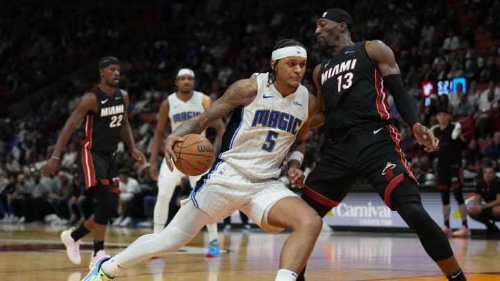 Feb 6, 2024; Orlando Magic forward Paolo Banchero (5) drives to the basket as Miami Heat center Bam Adebayo (13) defends during the second half at Kaseya Center.