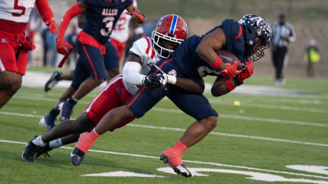 Allen's Lyndon Spriggs is tackled by a Duncanville defender in a Class 6A Division 1 semifinal game last December. 