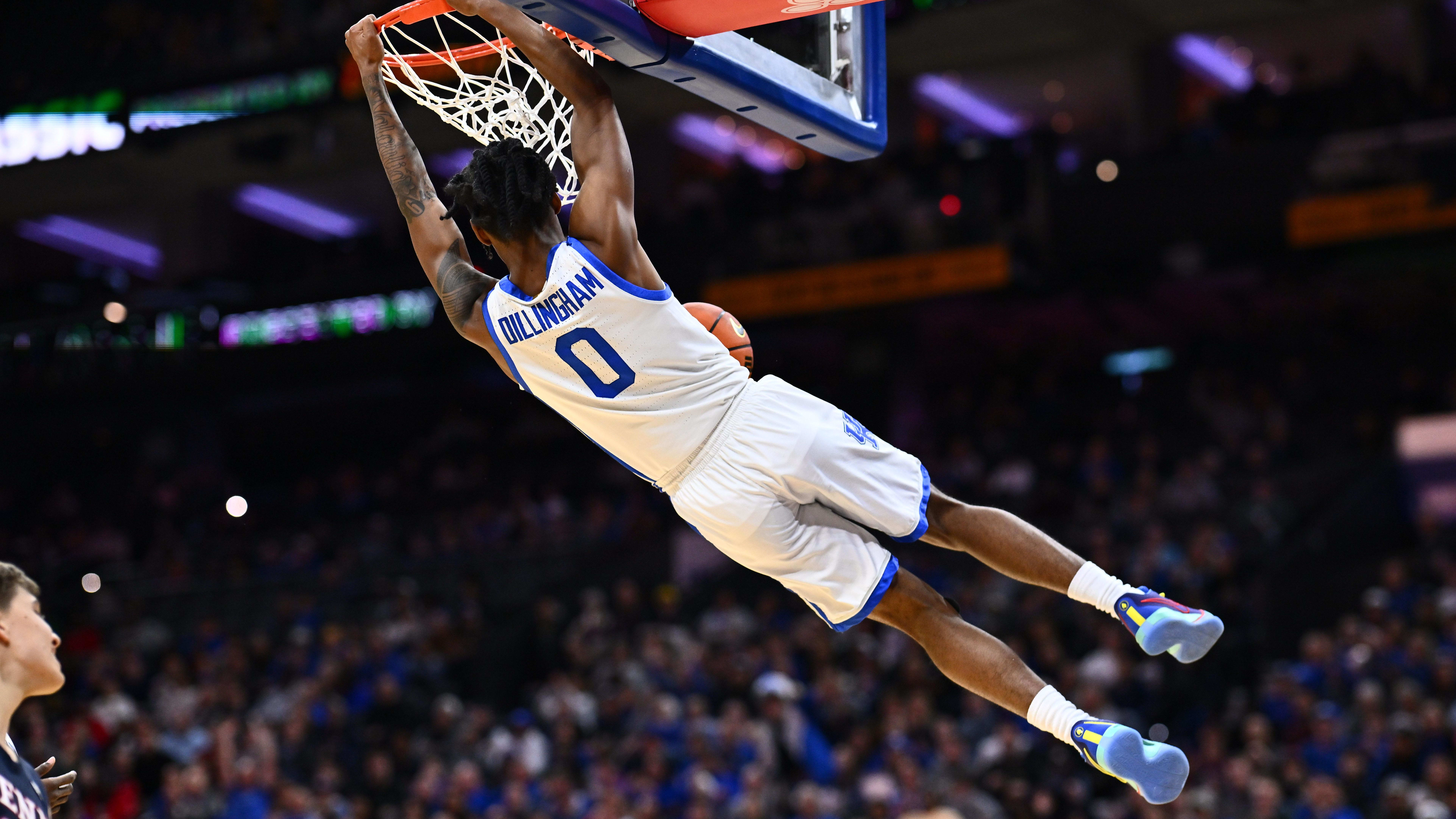 Kentucky Wildcats guard Rob Dillingham dunks during a game.