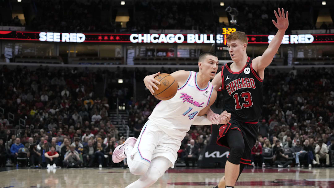Apr 9, 2025; Chicago, Illinois, USA; Chicago Bulls guard Kevin Huerter (13) defends Miami Heat guard Tyler Herro (14) during the second half at United Center. Mandatory Credit: David Banks-Imagn Images