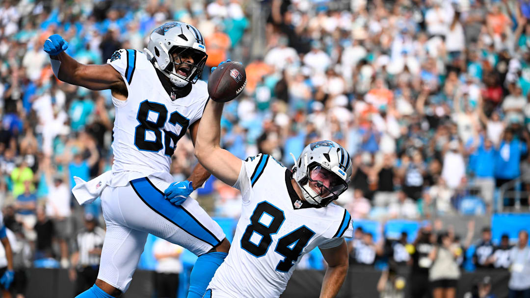 Oct 5, 2025; Charlotte, North Carolina, USA; Carolina Panthers tight end Mitchell Evans (84) spikes the ball after scoring the winning touchdown as tight end Tommy Tremble (82) celebrates in the background in the fourth quarter at Bank of America Stadium. Mandatory Credit: Bob Donnan-Imagn Images