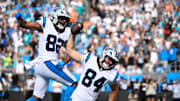 Oct 5, 2025; Charlotte, North Carolina, USA; Carolina Panthers tight end Mitchell Evans (84) spikes the ball after scoring the winning touchdown as tight end Tommy Tremble (82) celebrates in the background in the fourth quarter at Bank of America Stadium. Mandatory Credit: Bob Donnan-Imagn Images
