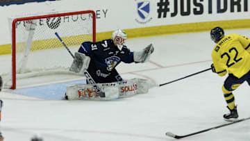 Aug 3, 2024; Plymouth, MI, USA; Finland's goaltender Kim Saarinen (31) makes a glove save on a break away shot from Sweden's forward Isac Hedqvist (22) during the second period of the 2024 World Junior Summer Showcase at USA Hockey Arena. Mandatory Credit: David Reginek-Imagn Images