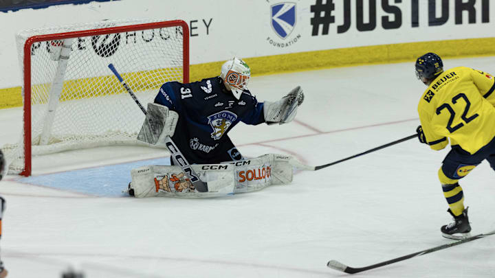 Aug 3, 2024; Plymouth, MI, USA; Finland's goaltender Kim Saarinen (31) makes a glove save on a break away shot from Sweden's forward Isac Hedqvist (22) during the second period of the 2024 World Junior Summer Showcase at USA Hockey Arena. Mandatory Credit: David Reginek-Imagn Images