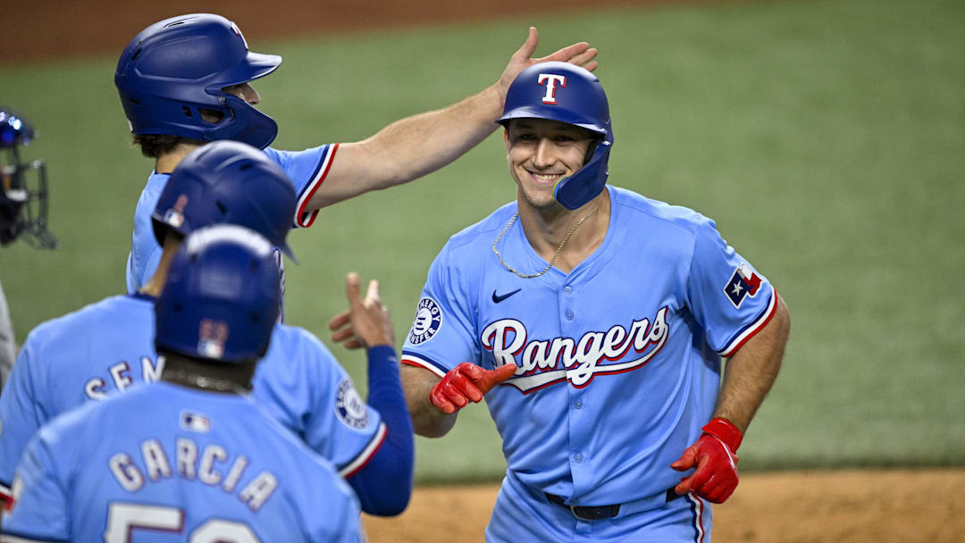 Sep 22, 2024; Arlington, Texas, USA; Texas Rangers left fielder Wyatt Langford (36) celebrates with shortstop Josh Smith (8) and second baseman Marcus Semien (2) and right fielder Adolis Garcia (53) after Langford hits a three run home run against the Seattle Mariners during the sixth inning at Globe Life Field. Mandatory Credit: Jerome Miron-Imagn Images