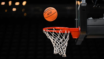 Mar 20, 2025; Seattle, WA, USA; A Wilson practice basketball with the March Madness logo goes into the basket during the Maryland Terrapins practice at Climate Pledge Arena. Mandatory Credit: Steven Bisig-Imagn Images