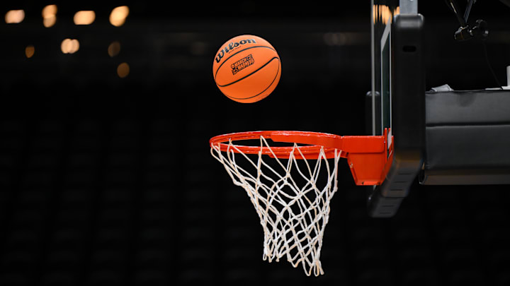 Mar 20, 2025; Seattle, WA, USA; A Wilson practice basketball with the March Madness logo goes into the basket during the Maryland Terrapins practice at Climate Pledge Arena. Mandatory Credit: Steven Bisig-Imagn Images