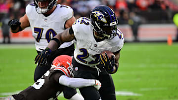 Nov 16, 2025; Cleveland, Ohio, USA; Baltimore Ravens running back Derrick Henry (22) runs for a gain past Cleveland Browns cornerback Myles Harden (26) during the first quarter at Huntington Bank Field. Mandatory Credit: Ken Blaze-Imagn Images