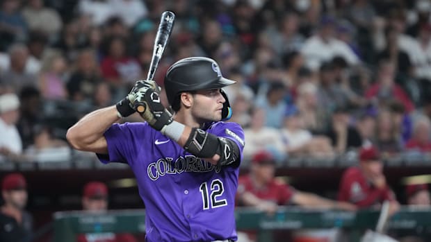 Colorado Rockies third base Kyle Karros prepares to swing his bat while wearing a purple jersey and black helmet