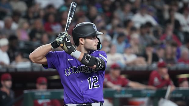 Colorado Rockies third base Kyle Karros prepares to hit while wearing a purple jersey and black batting helmet