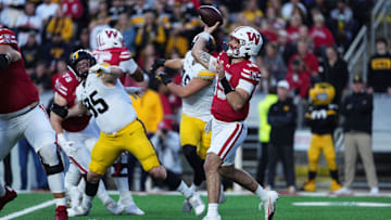 Oct 11, 2025; Madison, Wisconsin, USA; Wisconsin Badgers quarterback Hunter Simmons (15) attempts a pass in the first quarter against the Iowa Hawkeyes at Camp Randall Stadium. Mandatory Credit: Ross Harried-Imagn Images