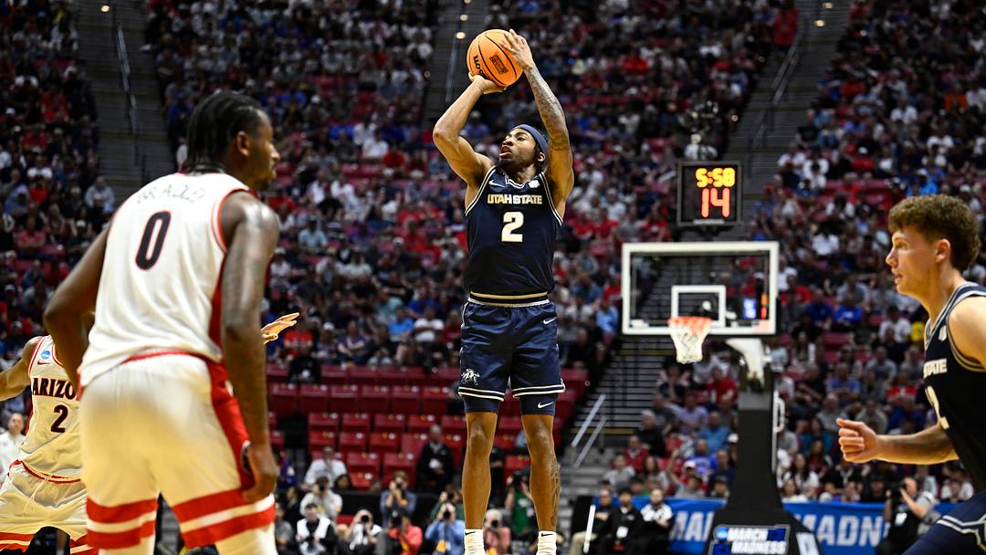 Mar 22, 2026; San Diego, CA, USA; Utah State Aggies guard Mj Collins (2) shoots against the Arizona Wildcats in the first half during a second round game of the men's 2026 NCAA Tournament at Viejas Arena. Mandatory Credit: Denis Poroy-Imagn Images