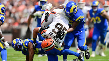 Los Angeles Rams linebacker Elias Neal (58) and safety Tanner Ingle (34) tackle Cleveland Browns tight end Blake Whiteheart (86) during the first half at Huntington Bank Field.