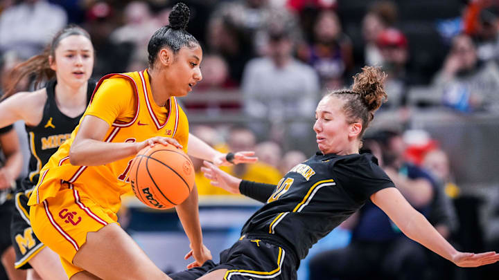Michigan Wolverines guard Jordan Hobbs (10) takes a charge from USC Trojans guard JuJu Watkins (12) on Saturday, March 8, 2025, in a semifinals game at the 2025 TIAA Big Ten Women's Basketball Tournament between the Iowa Hawkeyes and the Ohio State Buckeyes at Gainbridge Fieldhouse in Indianapolis.