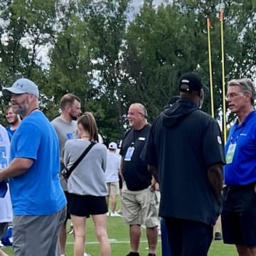 Detroit Lions general manager Brad Holmes converses with Rick Spielman.