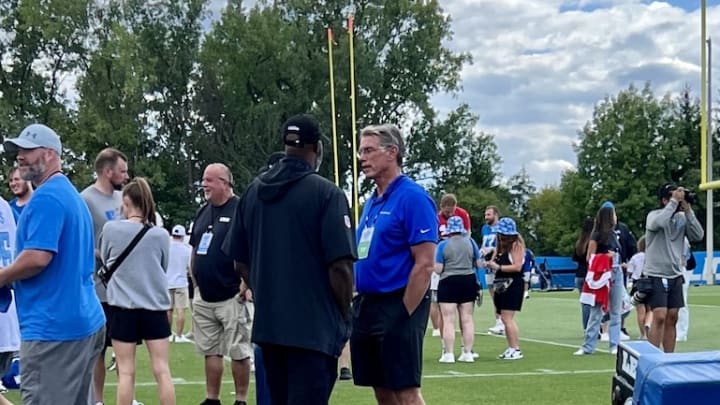 Detroit Lions general manager Brad Holmes converses with Rick Spielman.