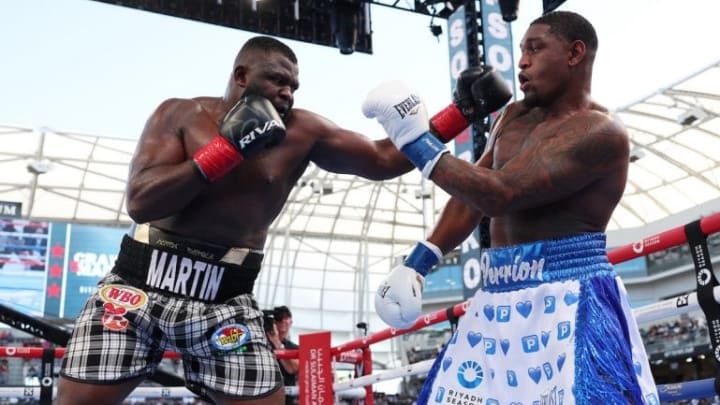 Martin Bakole [left] delivers a powerful two-punch combination to Jared Anderson [right], marking a turning point in the fight