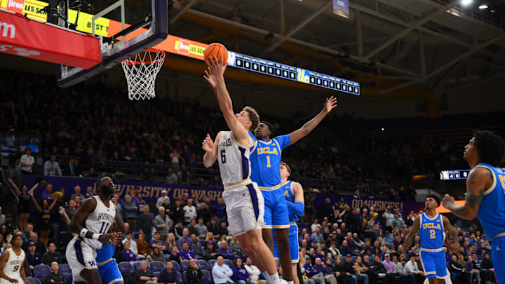 Dec 3, 2025; Seattle, Washington, USA; Washington Huskies forward Hannes Steinbach (6) shoots a layup while defended by UCLA Bruins center Xavier Booker (1) during the first half at Alaska Airlines Arena at Hec Edmundson Pavilion. Mandatory Credit: Steven Bisig-Imagn Images