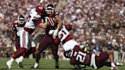 Nov 15, 2025; College Station, Texas, USA; Texas A&M Aggies defensive end T.J. Searcy (18) and linebacker Taurean York (21) attempt to tackle South Carolina Gamecocks running back Rahsul Faison (1) on a play during the second quarter at Kyle Field. Mandatory Credit: Troy Taormina-Imagn Images