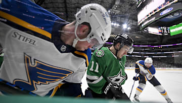 Mar 2, 2025; Dallas, Texas, USA; St. Louis Blues center Radek Faksa (12) and Dallas Stars center Logan Stankoven (11) battle for control of the puck during the first period at the American Airlines Center. Mandatory Credit: Jerome Miron-Imagn Images