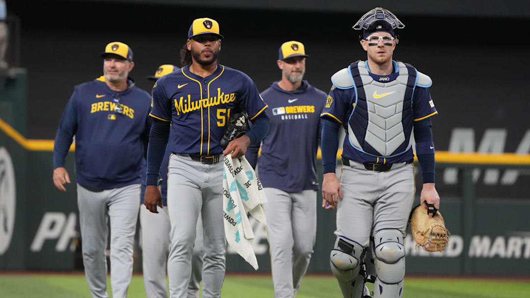 Sep 10, 2025; Arlington, Texas, USA; Milwaukee Brewers starting pitcher Freddy Peralta (51) and catcher Danny Jansen (33) walk to the dugout before the first inning against the Texas Rangers at Globe Life Field. Mandatory Credit: Jim Cowsert-Imagn Images