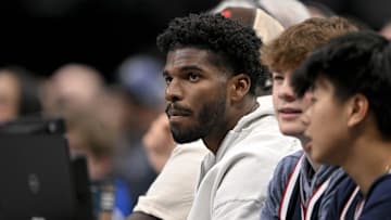 Jan 14, 2025; Dallas, Texas, USA; Colorado Buffaloes quarterback Shedeur Sanders watches the game between the Dallas Mavericks and the Denver Nuggets during the second quarter at the American Airlines Center. Mandatory Credit: Jerome Miron-Imagn Images