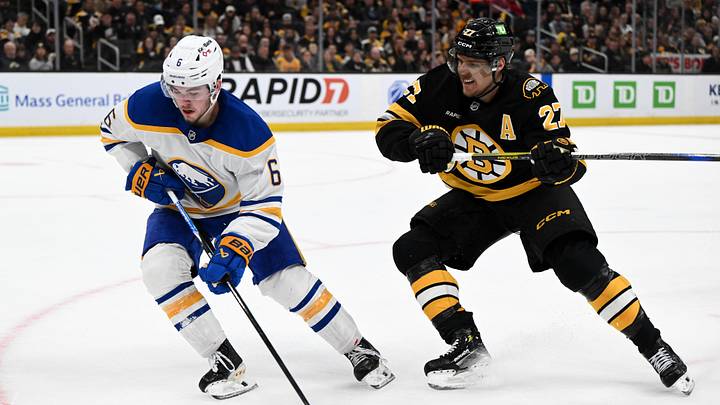 Apr 23, 2026; Boston, Massachusetts, USA; Buffalo Sabres left wing Zach Benson (6) skates against Boston Bruins defenseman Hampus Lindholm (27) during the second period of game three of the first round of the 2026 Stanley Cup Playoffs at the TD Garden. Mandatory Credit: Brian Fluharty-Imagn Images