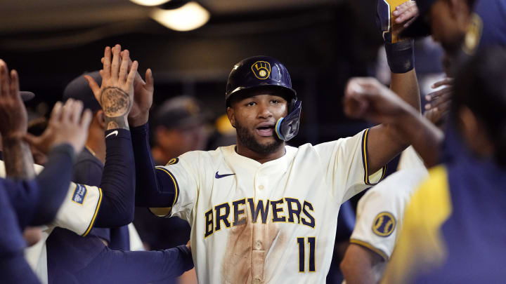 Jul 9, 2024; Milwaukee, Wisconsin, USA;  Milwaukee Brewers right fielder Jackson Chourio (11) celebrates in the dugout after scoring a run during the third inning against the Pittsburgh Pirates at American Family Field.