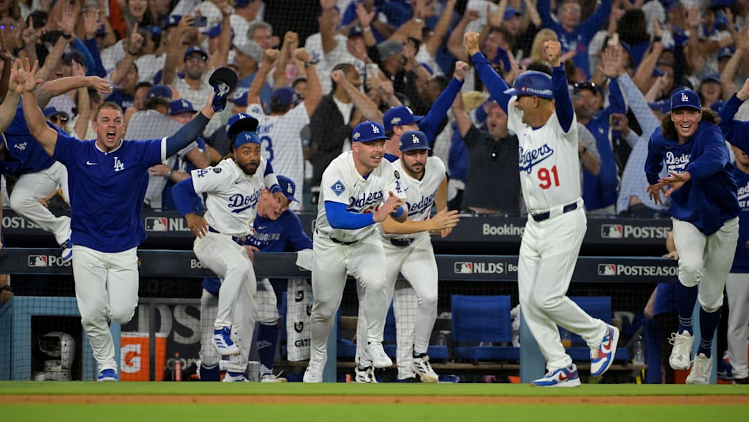 Los Angeles Dodgers catcher Ben Rortvedt (47), center fielder Justin Dean (75), catcher Dalton Rushing (68), relief pitcher Alex Vesia (51), third base coach Dino Ebel (91) and starting pitcher Tyler Glasnow (31) celebrate after final out of the 11th inning defeating the Philadelphia Phillies in Game 4 of the NLDS.