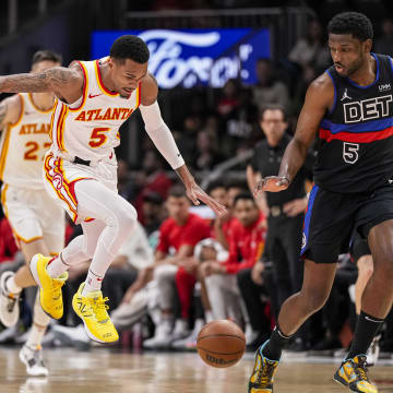 Apr 3, 2024; Atlanta, Georgia, USA; Atlanta Hawks guard Dejounte Murray (5) tries to control a loose ball between Detroit Pistons center Jalen Duren (0) and guard Jaylen Nowell (5) during the first half at State Farm Arena. Mandatory Credit: Dale Zanine-USA TODAY Sports
