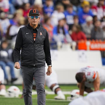 Nov 1, 2025; Lawrence, Kansas, USA; Oklahoma State Cowboys head coach Doug Meacham during warmups prior to a game against the Kansas Jayhawks at David Booth Kansas Memorial Stadium. Mandatory Credit: Jay Biggerstaff-Imagn Images