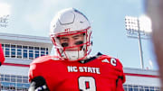 Oct 4, 2025; Raleigh, North Carolina, USA; NC State Wolfpack quarterback CJ Bailey (11), linebacker Caden Fordham (1), wide receiver Keenan Jackson (8) during the coin toss prior to the first half of the game against Campbell Fighting Camels at Carter-Finley Stadium. Mandatory Credit: Jaylynn Nash-Imagn Images