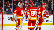 Apr 18, 2024; Calgary, Alberta, CAN; Calgary Flames goaltender Dustin Wolf (32) celebrate win with teammates after defeating San Jose Sharks at Scotiabank Saddledome. Mandatory Credit: Sergei Belski-USA TODAY Sports