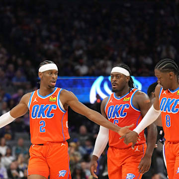 Dec 14, 2023; Sacramento, California, USA; Oklahoma City Thunder guard Shai Gilgeous-Alexander (2) walks to the bench with forwards Chet Holmgren (7) and Jalen Williams (8) and guard Luguentz Dort (second from right) during the fourth quarter against the Sacramento Kings at Golden 1 Center. Mandatory Credit: Darren Yamashita-Imagn Images