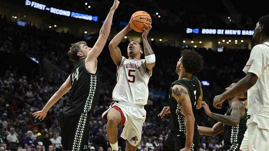 Arkansas Razorbacks guard Darius Acuff Jr. drives against Hawaii Rainbow Warriors forward Harry Rouhliadeff.