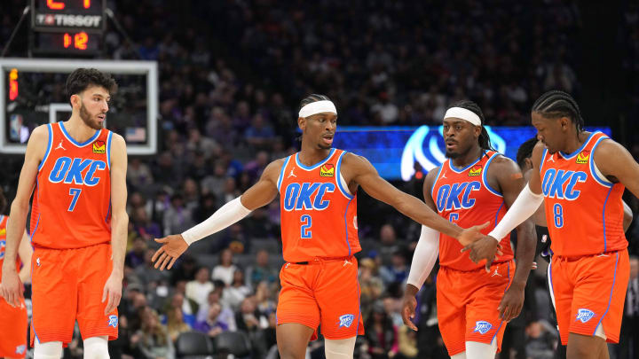 Dec 14, 2023; Sacramento, California, USA; Oklahoma City Thunder guard Shai Gilgeous-Alexander (2) walks to the bench with forwards Chet Holmgren (7) and Jalen Williams (8) and guard Luguentz Dort (second from right) during the fourth quarter against the Sacramento Kings at Golden 1 Center. Mandatory Credit: Darren Yamashita-USA TODAY Sports