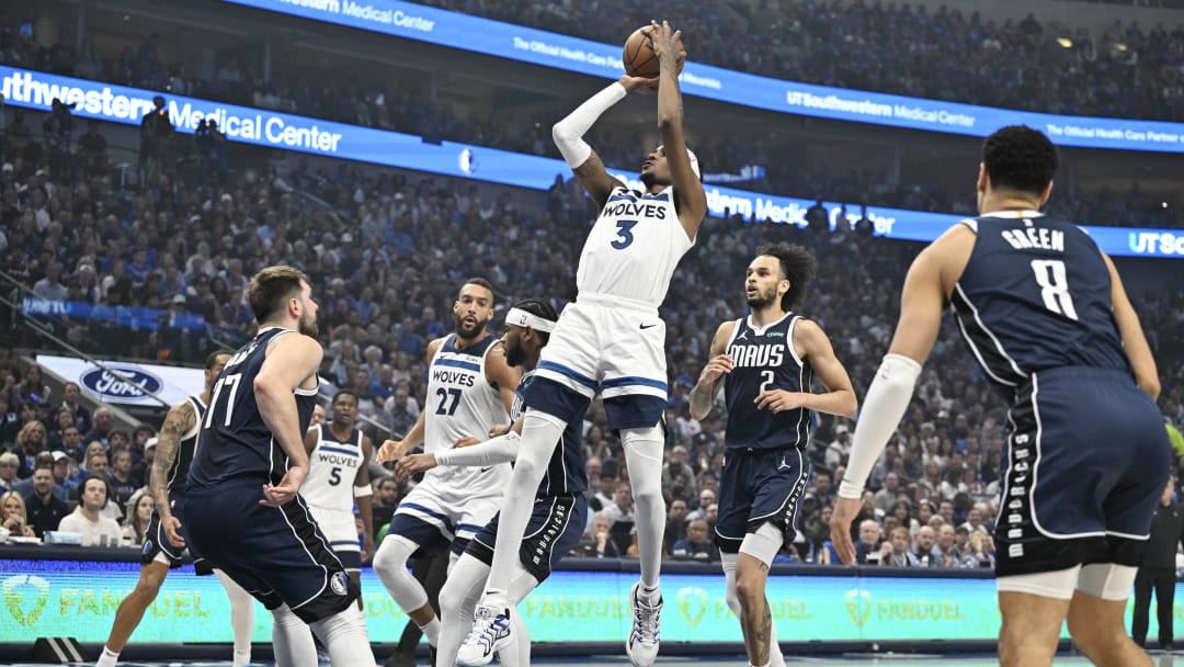 May 26, 2024; Dallas, Texas, USA; Minnesota Timberwolves forward Jaden McDaniels (3) shoots against the Dallas Mavericks in the first quarter during game three of the western conference finals for the 2024 NBA playoffs at American Airlines Center.