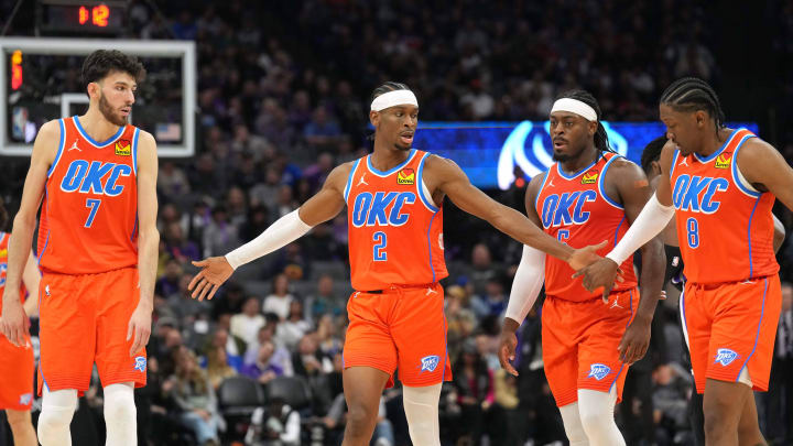 Dec 14, 2023; Sacramento, California, USA; Oklahoma City Thunder guard Shai Gilgeous-Alexander (2) walks to the bench with forwards Chet Holmgren (7) and Jalen Williams (8) and guard Luguentz Dort (second from right) during the fourth quarter against the Sacramento Kings at Golden 1 Center. Mandatory Credit: Darren Yamashita-USA TODAY Sports