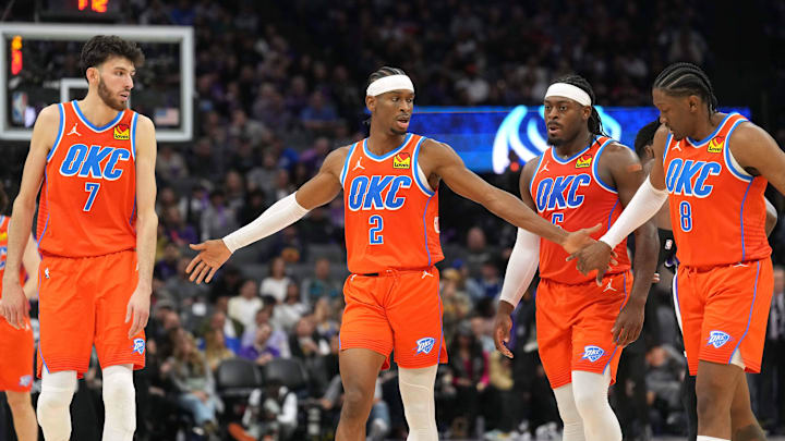 Dec 14, 2023; Sacramento, California, USA; Oklahoma City Thunder guard Shai Gilgeous-Alexander (2) walks to the bench with forwards Chet Holmgren (7) and Jalen Williams (8) and guard Luguentz Dort (second from right) during the fourth quarter against the Sacramento Kings at Golden 1 Center. Mandatory Credit: Darren Yamashita-Imagn Images