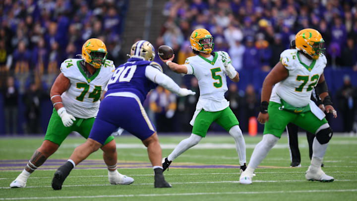 Nov 29, 2025; Seattle, Washington, USA; Oregon Ducks quarterback Dante Moore (5) passes the ball against the Washington Huskies during the second half at Husky Stadium. Mandatory Credit: Steven Bisig-Imagn Images