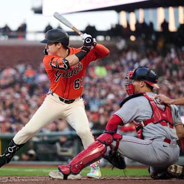 Aug 8, 2025; San Francisco, California, USA; San Francisco Giants right fielder Drew Gilbert (61) bats against Washington Nationals catcher Drew Millas (81) in his MLB debut during the second inning at Oracle Park. Mandatory Credit: Robert Edwards-Imagn Images