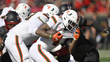 Oct 19, 2024; Louisville, Kentucky, USA; Miami Hurricanes running back Mark Fletcher Jr. (4) runs the ball against the Louisville Cardinals during the first half at L&N Federal Credit Union Stadium. Mandatory Credit: Jamie Rhodes-Imagn Images