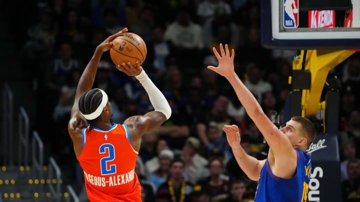 Dec 16, 2023; Denver, Colorado, USA; Oklahoma City Thunder guard Shai Gilgeous-Alexander (2) shoots the ball over Denver Nuggets center Nikola Jokic (15) in the fourth quarter at Ball Arena. Mandatory Credit: Ron Chenoy-USA TODAY Sports