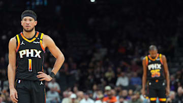 Feb 11, 2025; Phoenix, Arizona, USA; Phoenix Suns guard Devin Booker (1) and Phoenix Suns forward Kevin Durant (35) look on against the Memphis Grizzlies during the first half at Footprint Center. Mandatory Credit: Joe Camporeale-Imagn Images