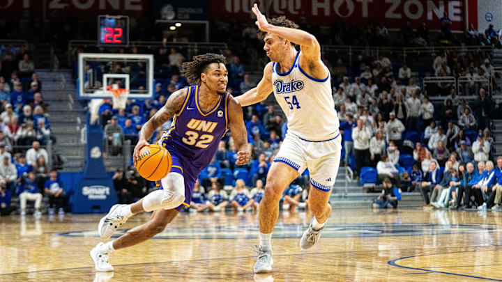 Northern Iowa's Tytan Anderson (32) drives past Drake's Daniel Abreu (54) on Wednesday, Jan. 29, 2025, at the Knapp Center.
