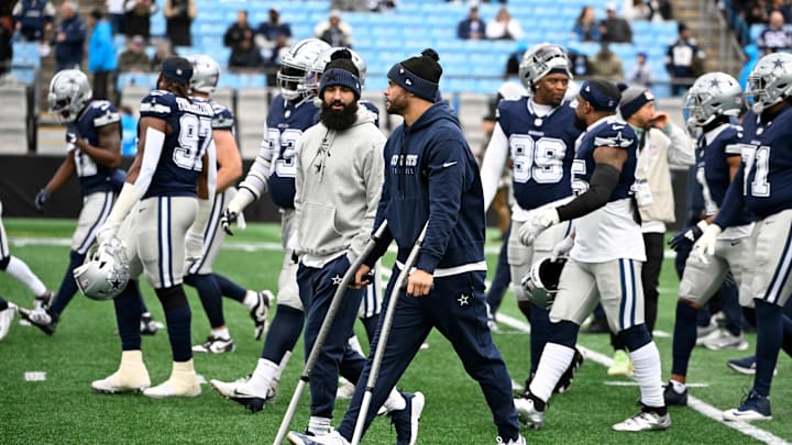 Dallas Cowboys quarterback Dak Prescott walks off the field with the team before a game against the Carolina Panthers. Dallas Cowboys quarterback Dak Prescott walks off the field with the team before a game against the Carolina Panthers.