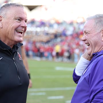 Arkansas head coach Sam Pittman talks to LSU head coach Brian Kelly prior to a game at Razorback Stadium. 