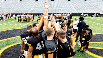Aug 9, 2025; Iowa’s Rhys Dakin, center, holds his hand up while huddling with special teams teammates during the Hawkeyes Kids Day NCAA football open practice at Kinnick Stadium in Iowa City, Iowa. Mandatory Credit: Joseph Cress for the Des Moines Register