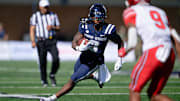 Sep 14, 2024; Logan, Utah, USA;  Utah State Aggies running back Rahsul Faison (3) runs with the ball against the Utah Utes at Merlin Olsen Field at Maverik Stadium. Mandatory Credit: Jamie Sabau-Imagn Images